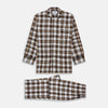 View 1 of product The Turnbull & Asser Brown Multi Check Linen Hyde Pyjama Set features a button-up, long-sleeve top and pants with a brown, black, and white plaid pattern, shown on a white background.