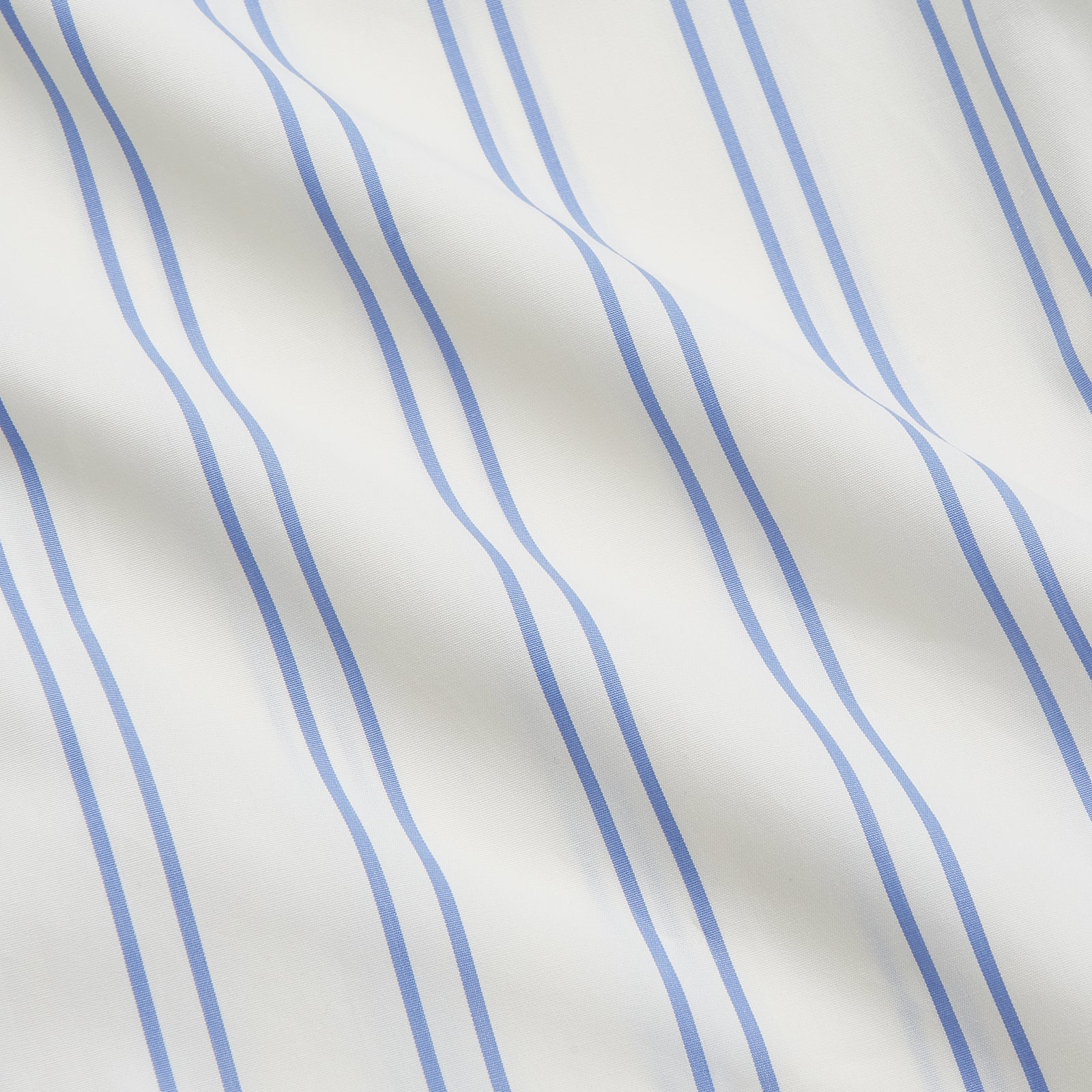 View 4 of product The Turnbull & Asser Women's Blue Multi Cotton Thelma Pyjama Set features a long-sleeve button-up shirt with collar and pocket, plus matching drawstring pants, elegantly displayed against a white background.