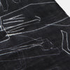 View 3 of product The Turnbull & Asser Black Sketched Pattern Wool Chilcott Scarf features white abstract lines, frayed edges, and is shown loosely knotted on a light gray background.