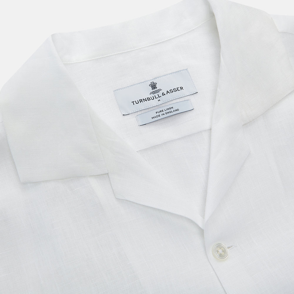 The Turnbull & Asser White Linen Holiday Fit Winnington Shirt, a long-sleeve style with a revere collar and chest pocket, is shown laid flat on a white background.