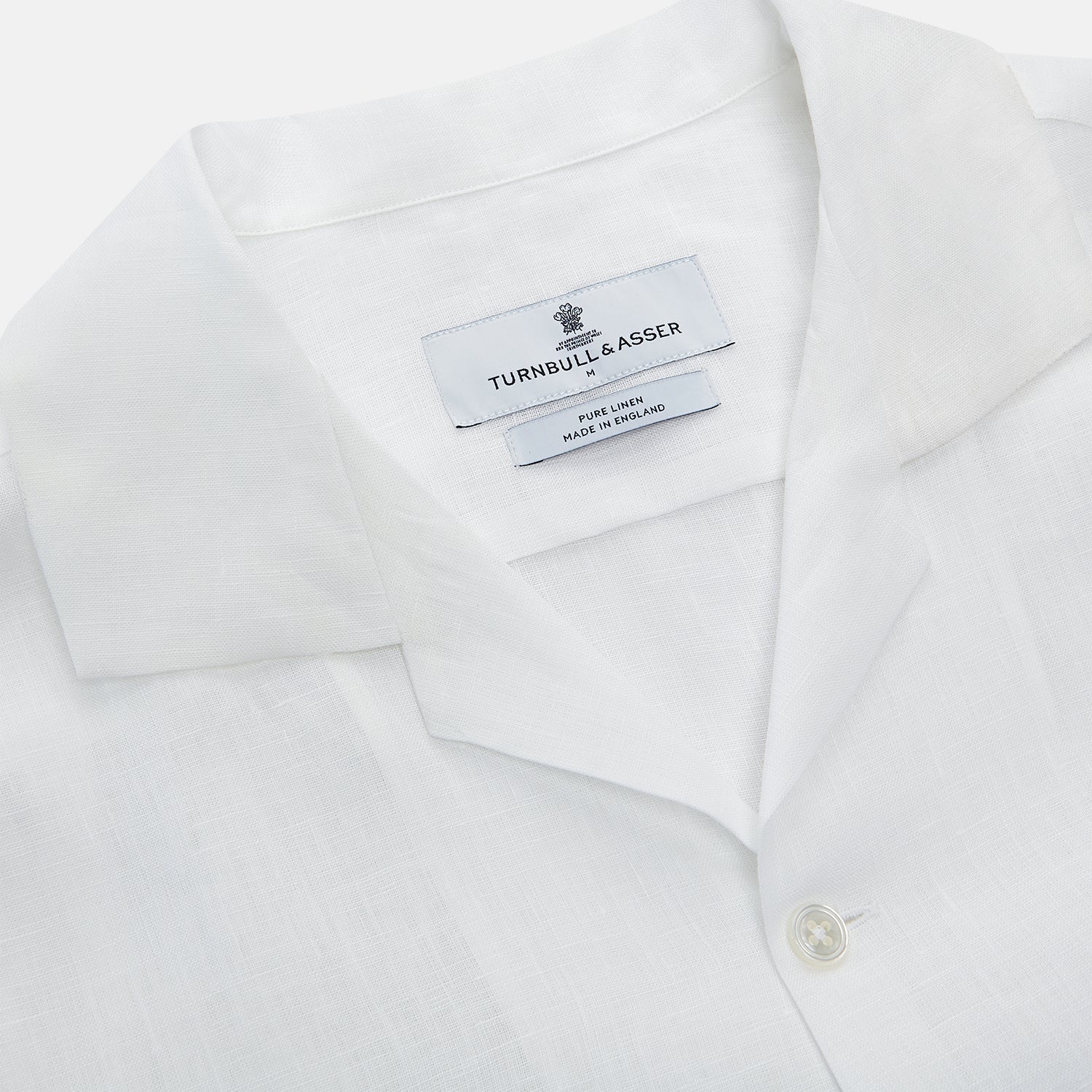 View 3 of product The Turnbull & Asser White Linen Holiday Fit Winnington Shirt, a long-sleeve style with a revere collar and chest pocket, is shown laid flat on a white background.