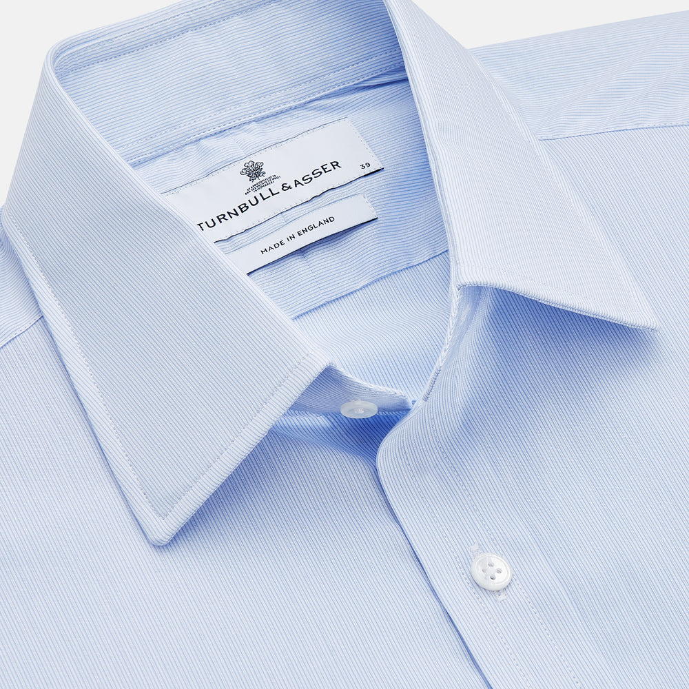 The Turnbull & Asser Pale Blue Multi Stripe Cotton Regular Fit Whitby Shirt features long sleeves, a classic collar, and buttoned cuffs, shown laid flat on a white background.