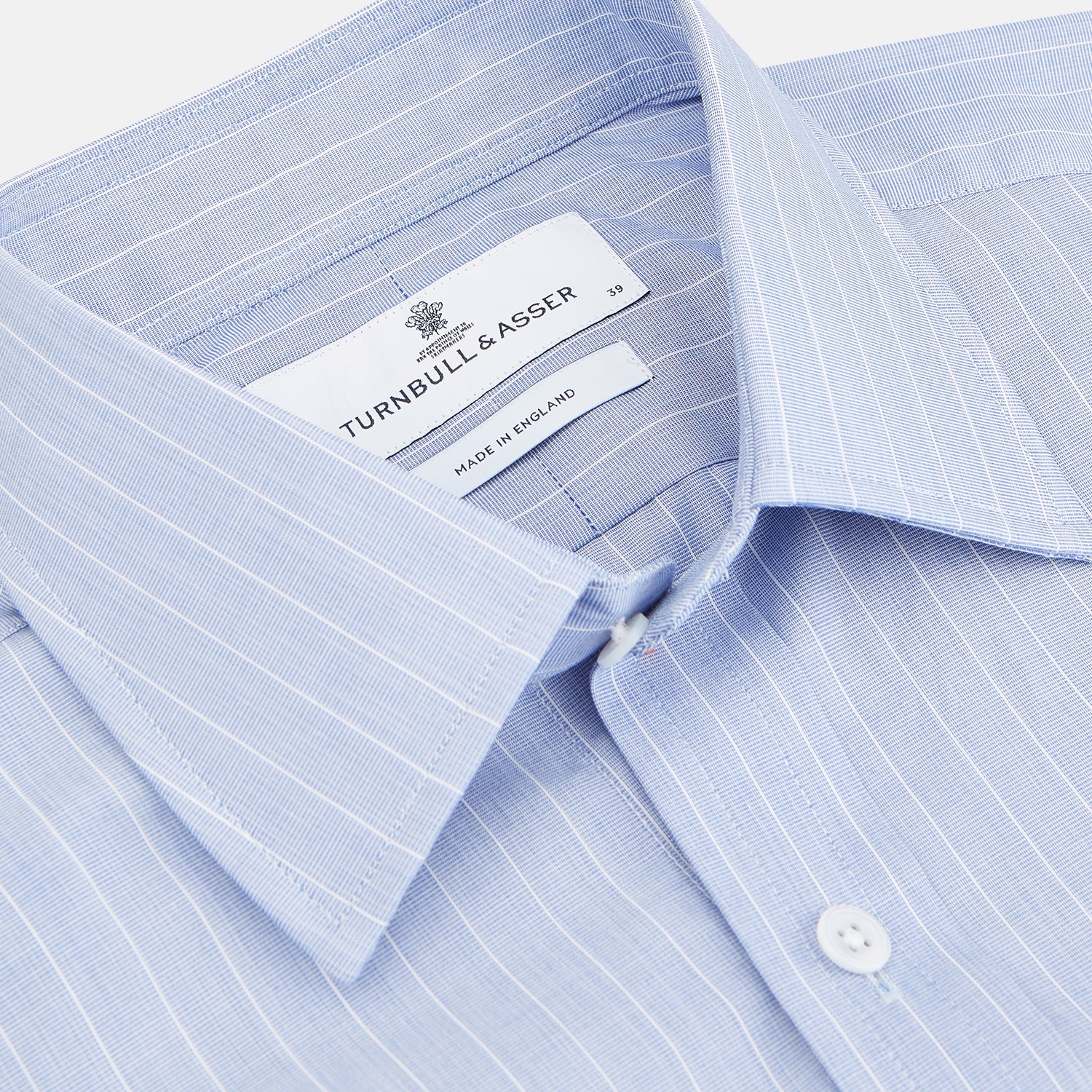 View 3 of product Navy Turnbull & Asser Mayfair shirt in textured cotton, regular fit with a sharp T&A collar and white buttons, laid flat on a white background.