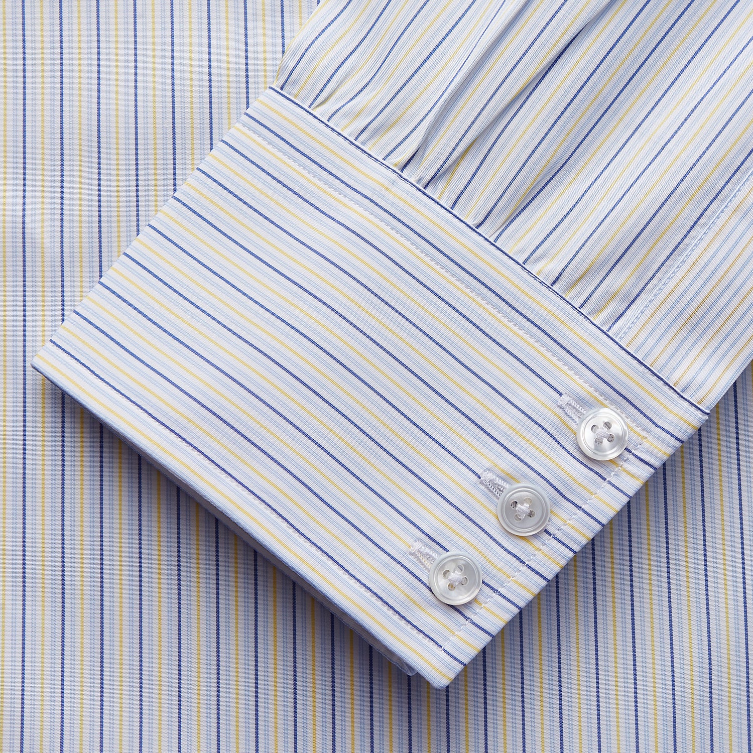 View 2 of product The Light Blue and Yellow Stripe Cotton RE-PURPOSE Mayfair Shirt by Turnbull & Asser features long sleeves, a classic collar, buttoned cuffs, a curved hem, and is made from recycled cotton for sustainable style.