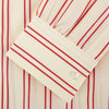 View 4 of product A man poses against a beige backdrop in the Turnbull & Asser Red and Off-White Stripe Cotton Weekend Fit Finch Shirt, styled with dark blue jeans and a brown belt for a timeless look. One hand rests in his pocket as he faces slightly to the side.