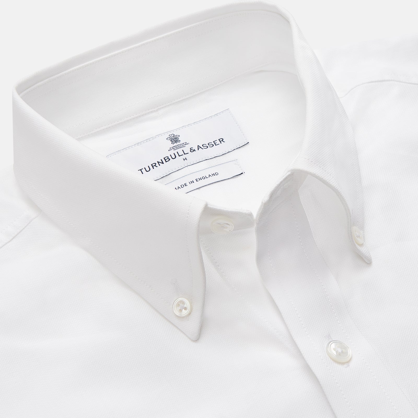 View 2 of product The Turnbull & Asser White Cotton Voile Weekend Fit Nevis Shirt features a Dorset button-down collar, two chest pockets, and a subtle military-inspired design, shown against a plain white background.