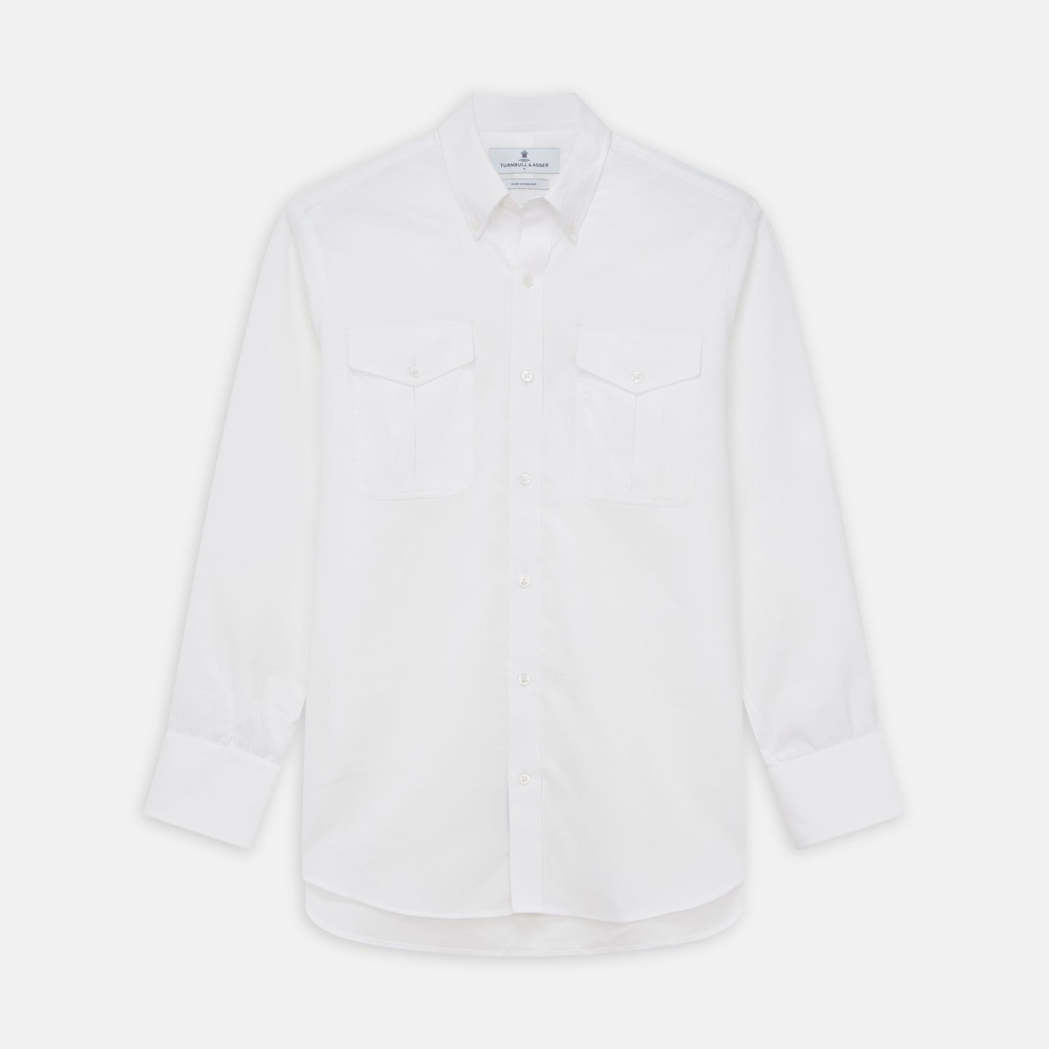 View 1 of product The Turnbull & Asser White Cotton Voile Weekend Fit Nevis Shirt features a Dorset button-down collar, two chest pockets, and a subtle military-inspired design, shown against a plain white background.
