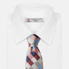 View 2 of product The Turnbull & Asser Pink and Blue Checkerboard Silk Tie is shown rolled up, highlighting its pink, blue, grey, and white pattern against a plain white background.