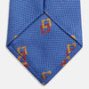 View 4 of product The Blue Geometric Squares Silk Tie by Turnbull & Asser features a classic blue base with small yellow and red geometric shapes, making it a sophisticated textured silk accessory.