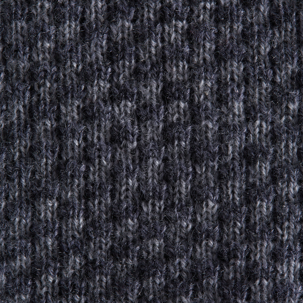 The Grey Multi Cashmere Knitted Tie by Turnbull & Asser features a textured checkered pattern, rolled and displayed on a white background—a refined menswear essential.