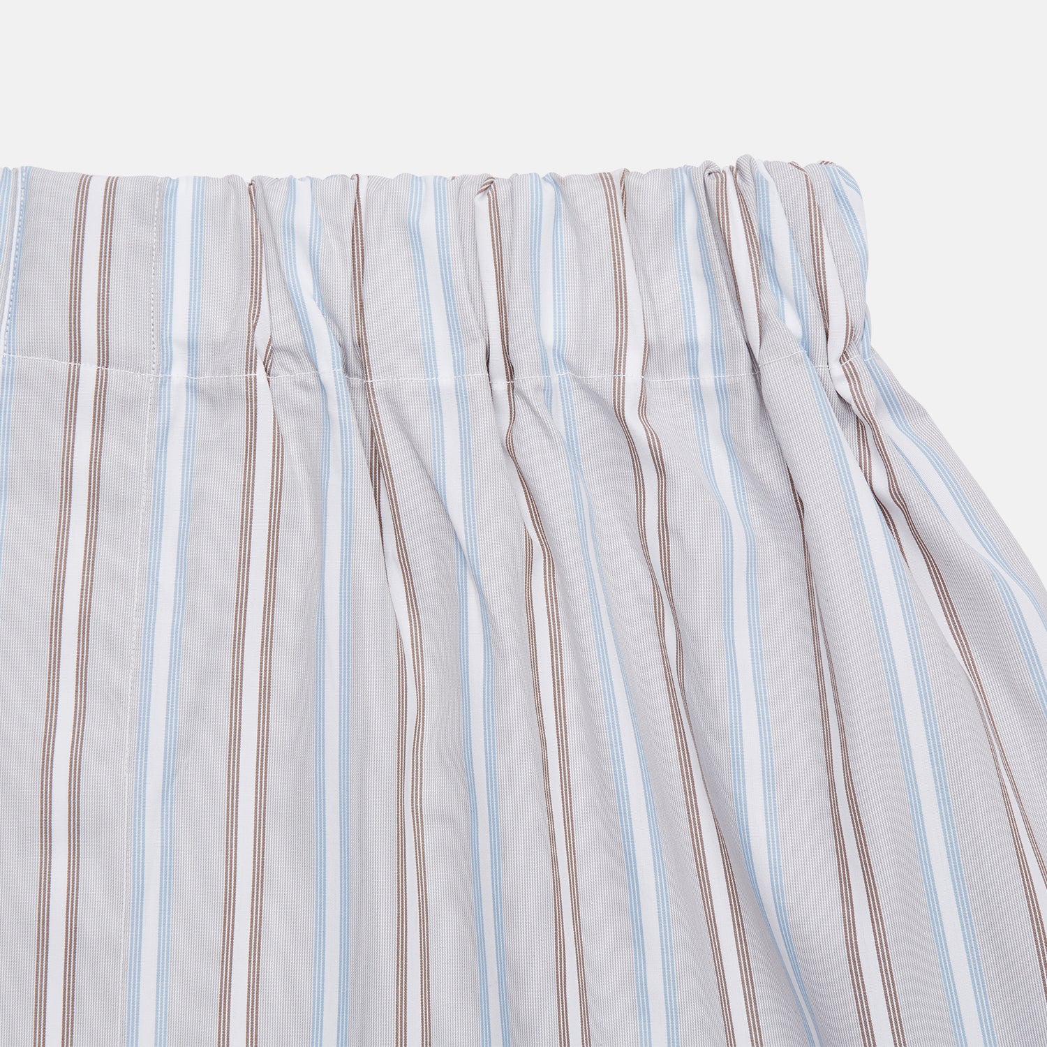 View 2 of product Turnbull & Asser’s Beige and Light Blue Multi Stripe Cotton Godfrey Boxer Shorts feature vertical blue, brown, and white stripes, an elastic waistband, and a comfortable loose fit. Displayed on a plain white background.