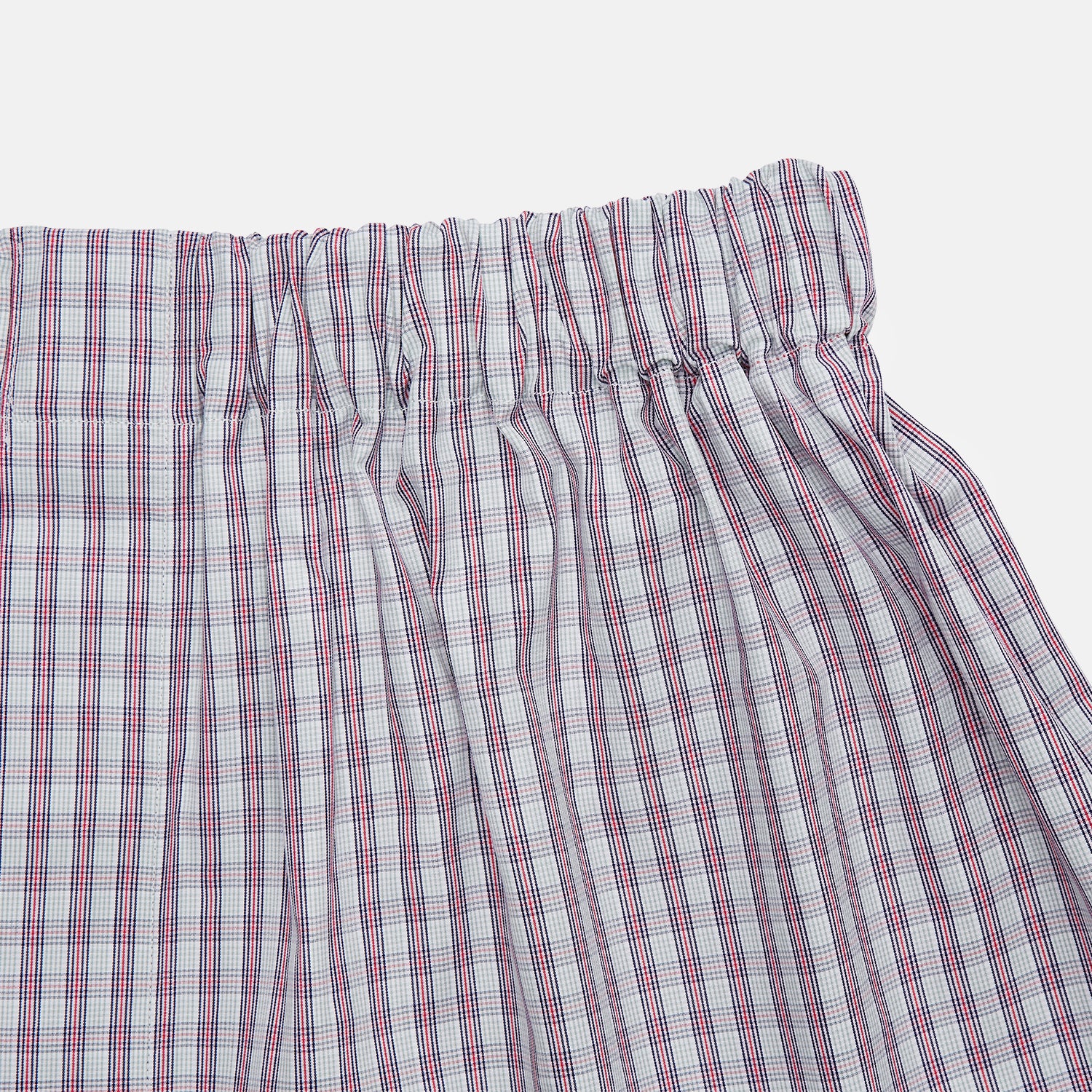 View 2 of product Turnbull & Asser Red and Blue Multi Check Cotton Godfrey Boxers feature a loose fit, knee-length cut, and elastic waistband in a red and blue plaid pattern on white, displayed on a plain background.