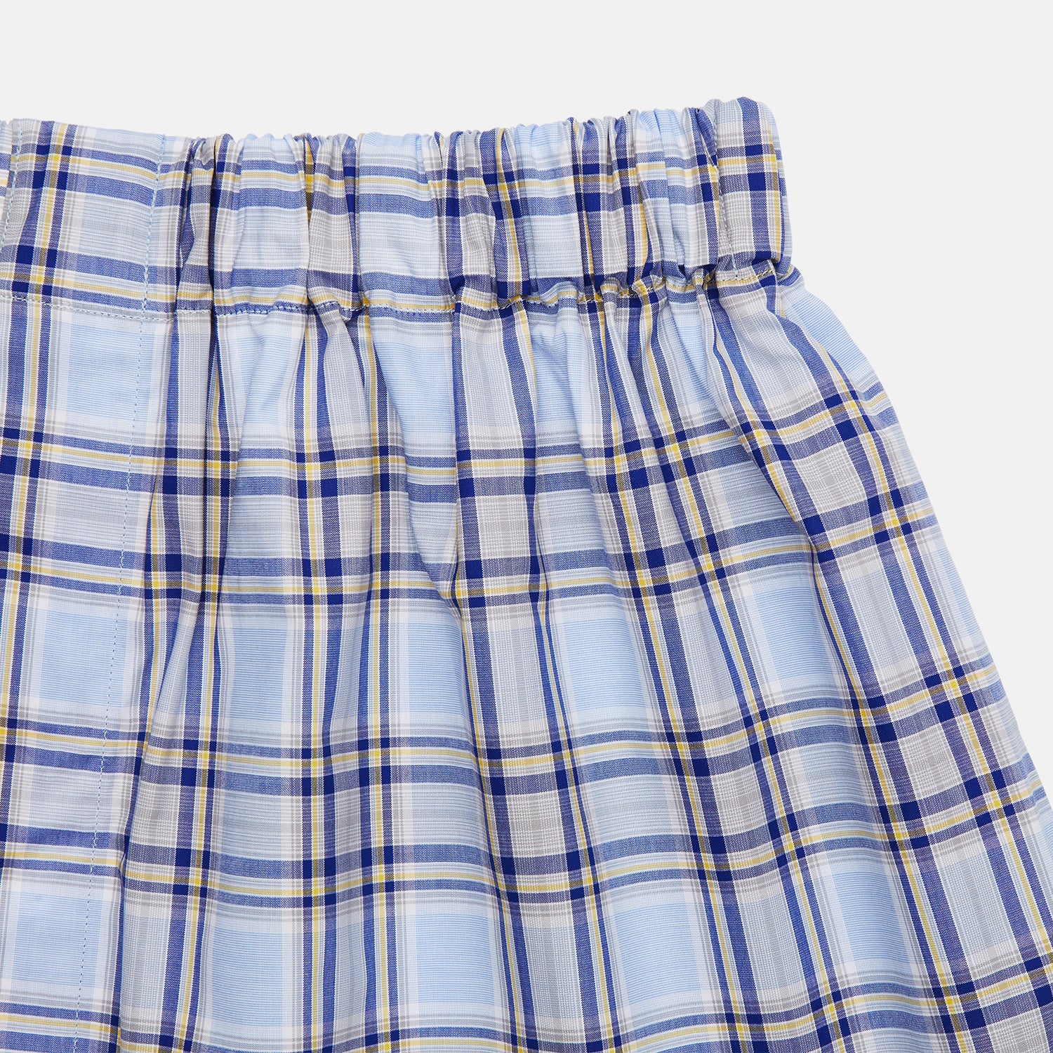 View 2 of product Pale Blue and Yellow Multi Check Cotton Godfrey Boxers by Turnbull & Asser, featuring a checkered pattern and elastic waistband, are displayed flat against a plain white background.