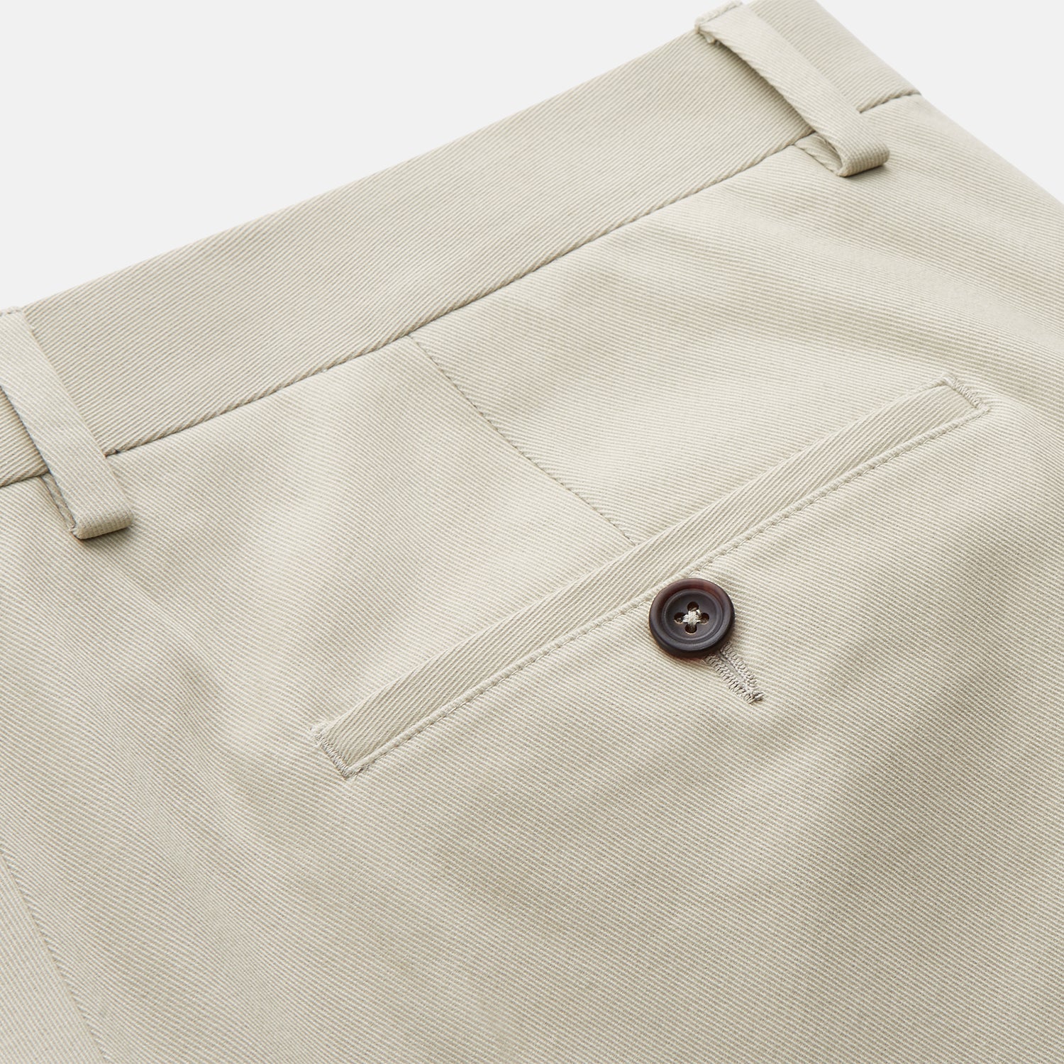 View 2 of product Turnbull & Asser Cream Cotton Manson Trousers feature a straight-leg fit, front button and zipper closure, belt loops, side pockets, and a pressed crease down each leg, shown against a white background.