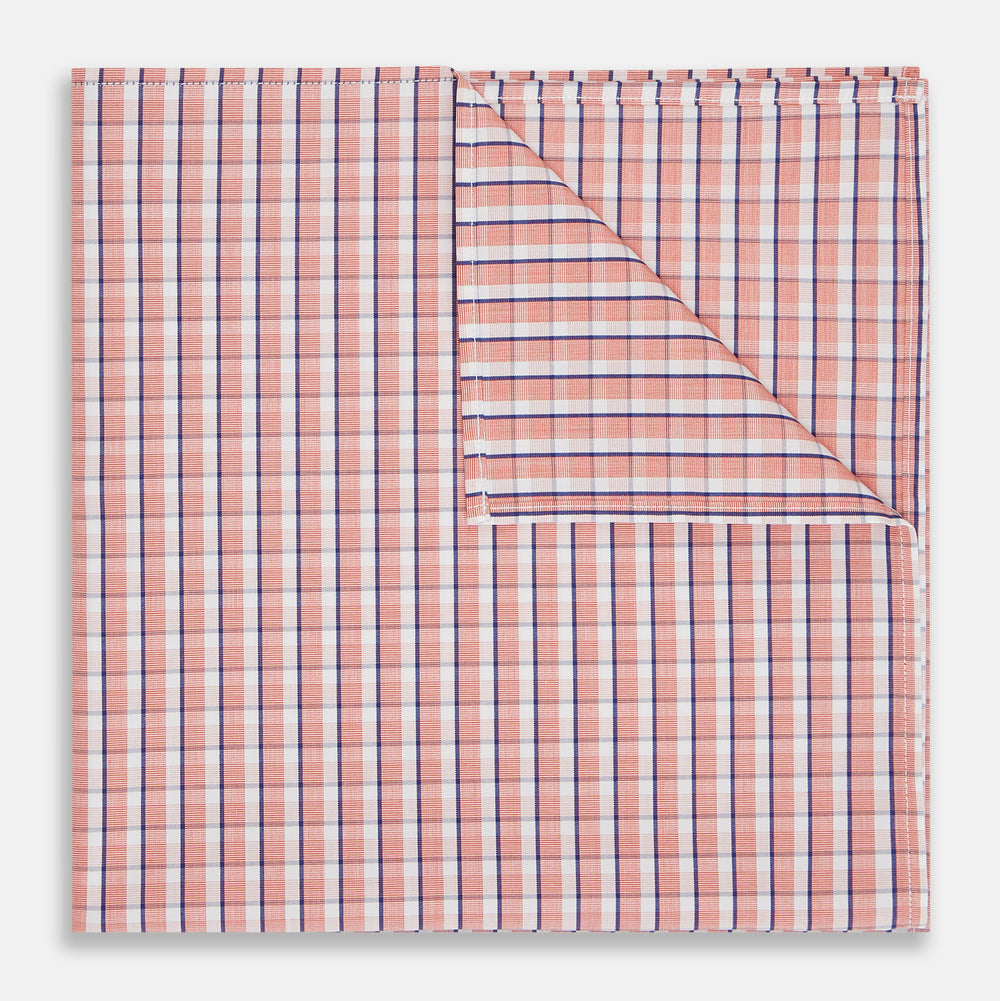 A neatly folded Turnbull & Asser Orange and White Check Cotton Handkerchief, with one corner turned up to show the reverse side.