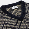 View 2 of product The Turnbull & Asser Navy and White Wool Blend Albion Chunky Slipover is a sleeveless knitted vest with ribbed V-neck, armholes, and hem, featuring a bold chevron pattern.