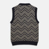 View 3 of product The Turnbull & Asser Navy and White Wool Blend Albion Chunky Slipover is a sleeveless knitted vest with ribbed V-neck, armholes, and hem, featuring a bold chevron pattern.