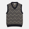 View 1 of product The Turnbull & Asser Navy and White Wool Blend Albion Chunky Slipover is a sleeveless knitted vest with ribbed V-neck, armholes, and hem, featuring a bold chevron pattern.