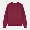 View 3 of product The Turnbull & Asser Soft Burgundy Cashmere Glenn Jumper, a menswear essential with long sleeves and a crew neck in solid dark red, is laid flat on a white background.