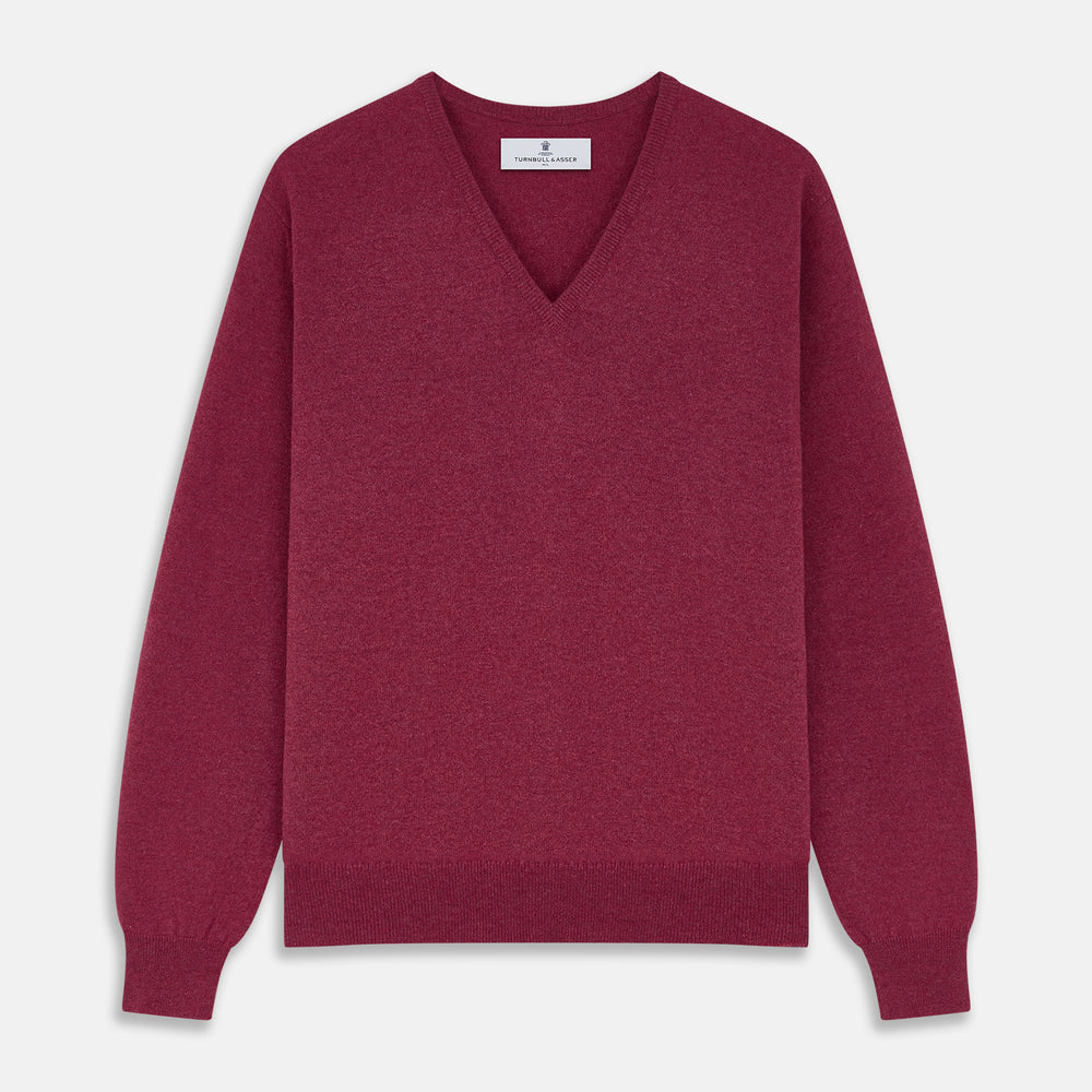The Turnbull & Asser Soft Burgundy Cashmere V-neck Paden Jumper is displayed flat on a white background, showing off its soft texture and subtle ribbed cuffs and hem.