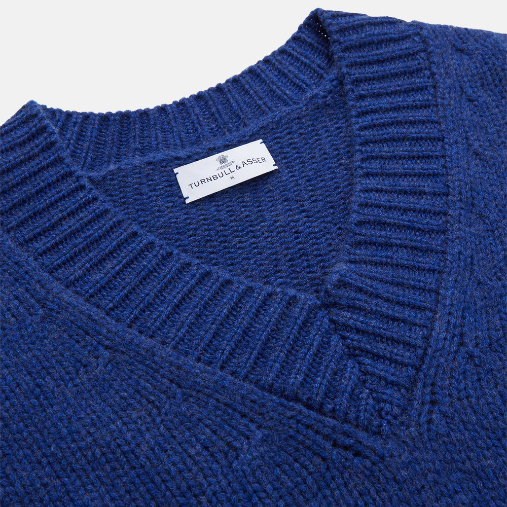 Turnbull & Asser's Marine Blue Cashmere Edwards V-Neck Jumper is inspired by vintage cricket sweaters, featuring ribbed cuffs, hem, and neckline. Shown against a plain white background.