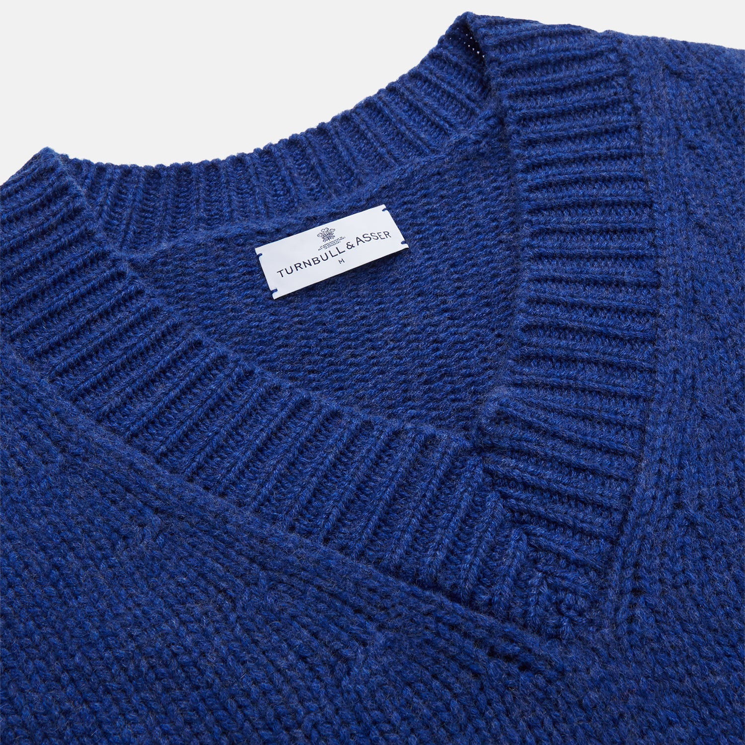 View 2 of product Turnbull & Asser's Marine Blue Cashmere Edwards V-Neck Jumper is inspired by vintage cricket sweaters, featuring ribbed cuffs, hem, and neckline. Shown against a plain white background.