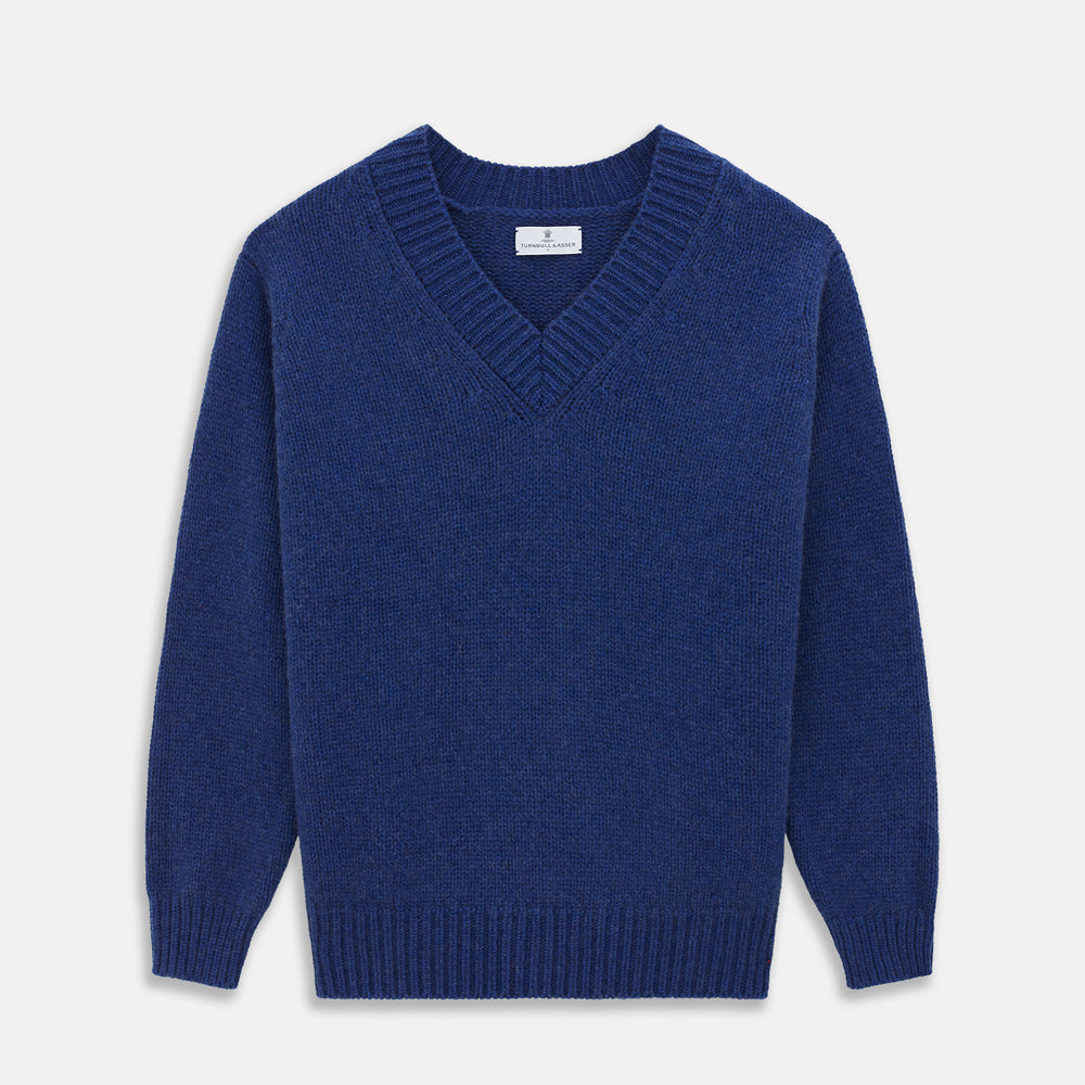 Turnbull & Asser's Marine Blue Cashmere Edwards V-Neck Jumper is inspired by vintage cricket sweaters, featuring ribbed cuffs, hem, and neckline. Shown against a plain white background.