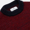 View 2 of product The Turnbull & Asser Red and Navy Wool Blend Billy Jumper features a red knit body with navy ribbed collar, cuffs, and hem, made from a wool and cotton blend, shown on a white background.