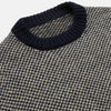 View 2 of product The Turnbull & Asser Navy and White Wool Blend Billy Jumper features a small checkered pattern with ribbed black collar, cuffs, and hem. Shown laid flat on a white background.