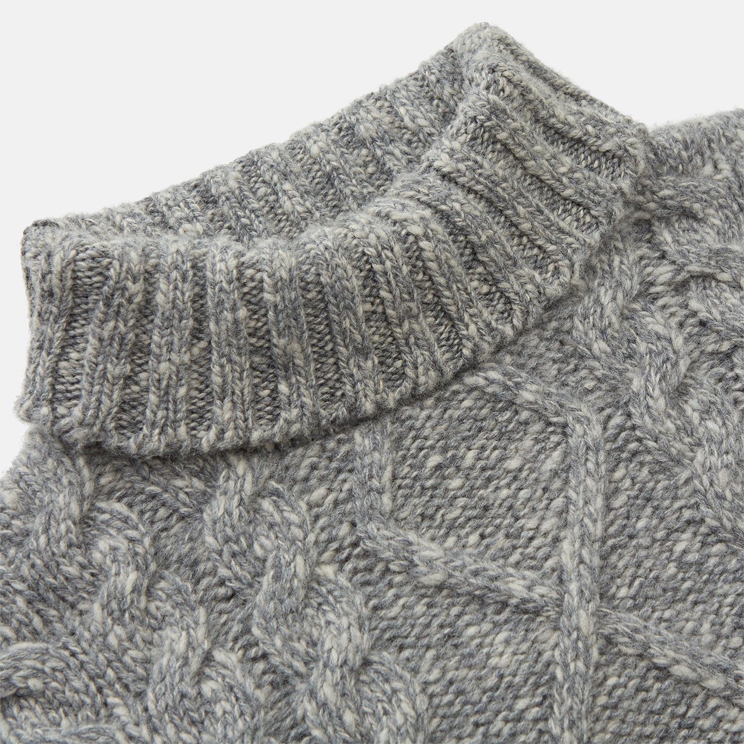 View 2 of product The Oatmeal Cashmere Melange Clark Roll Neck Jumper by Turnbull & Asser features a high roll-neck, long sleeves, and a textured cable knit front, crafted from a soft cashmere blend.