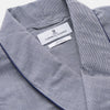 View 4 of product The Navy Houndstooth Wool Arnold Gown by Turnbull & Asser features a shawl collar, front chest pocket, long sleeves, and a matching fabric belt tied at the waist.