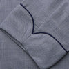 View 3 of product The Navy Houndstooth Wool Arnold Gown by Turnbull & Asser features a shawl collar, front chest pocket, long sleeves, and a matching fabric belt tied at the waist.