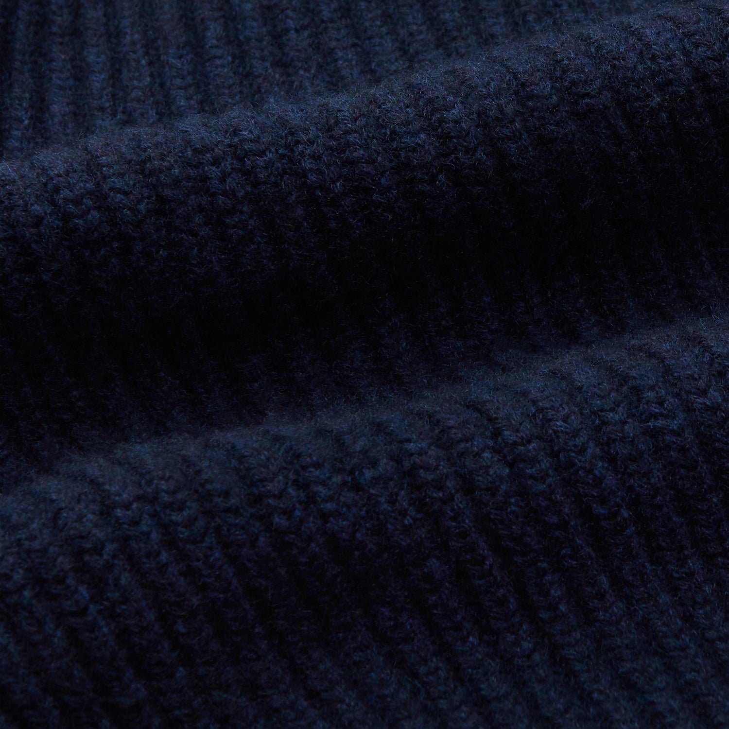 View 3 of product The Deep Navy Cashmere Baldwin Gown by Turnbull & Asser features a ribbed knit, long sleeves, shawl collar, two front pockets, and a waist tie—ideal as luxury loungewear or a chic navy dressing gown.