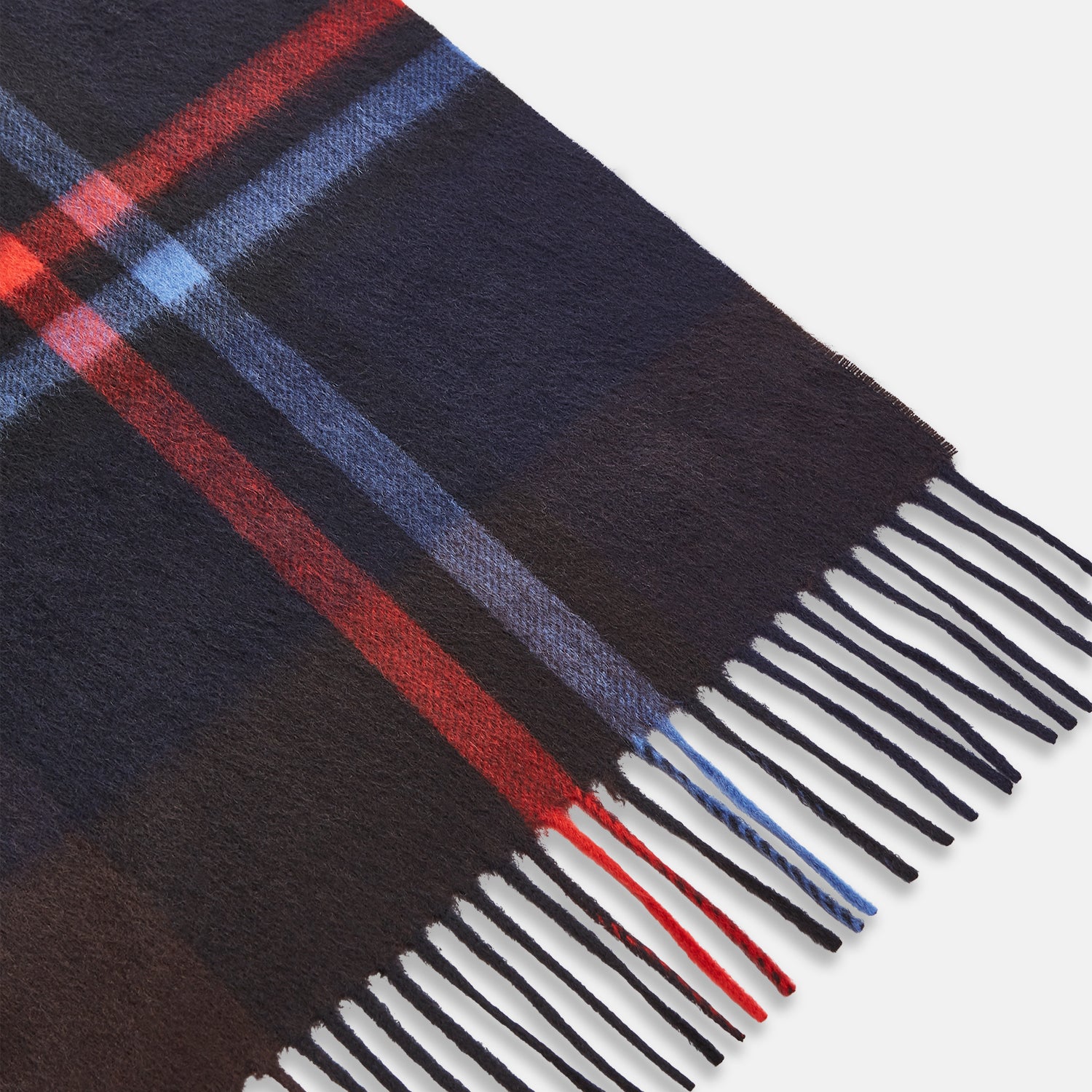 View 2 of product The Turnbull & Asser Deep Navy and Rich Brown Check Cashmere Scarf features a classic plaid pattern with fringed ends—an elegant winter accessory, beautifully shown against a white background.