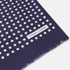 View 2 of product The Turnbull & Asser Navy and Cream Spotted Silk and Wool Scarf features white polka dots, a visible label, slightly frayed edges, and a hand-printed look for unique style.
