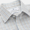 View 3 of product The Turnbull & Asser Blue Tattersall Check Cashmerello Regular Fit Mayfair Shirt is a long-sleeve button-up with a collar and chest pocket, featuring a white base and blue checks, shown laid flat on a white background.
