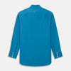 View 5 of product The Turnbull & Asser Blue Silk Regular Fit Mayfair Shirt features long sleeves, a pointed collar, and white buttons in a solid bright blue; displayed flat on a white background.