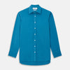 View 1 of product The Turnbull & Asser Blue Silk Regular Fit Mayfair Shirt features long sleeves, a pointed collar, and white buttons in a solid bright blue; displayed flat on a white background.