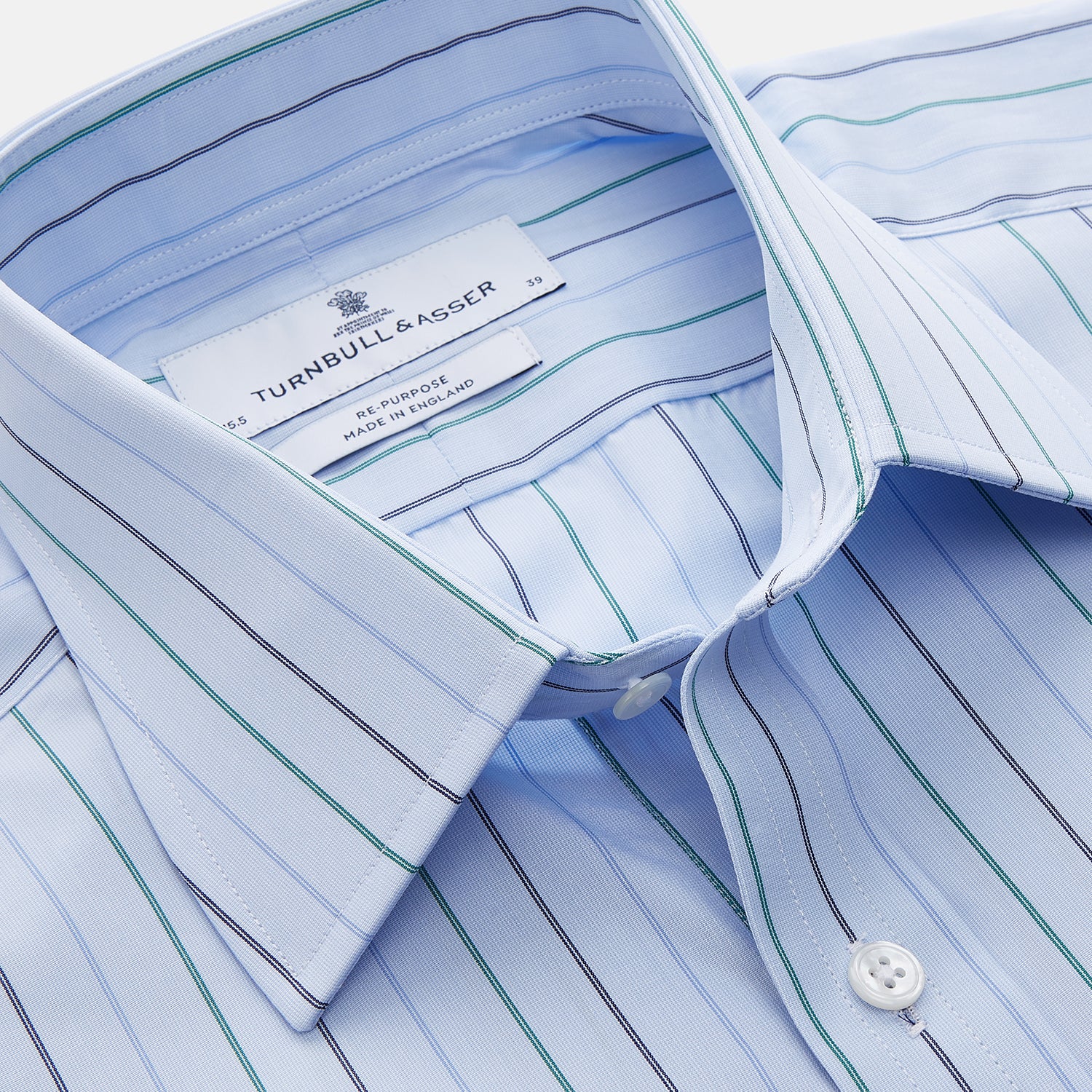 View 3 of product The Turnbull & Asser Pale Blue and Green Halo Stripe Cotton Regular Fit Mayfair Shirt features subtle stripes, long sleeves, a signature T&A collar, and cuffed sleeves, shown against a white background.