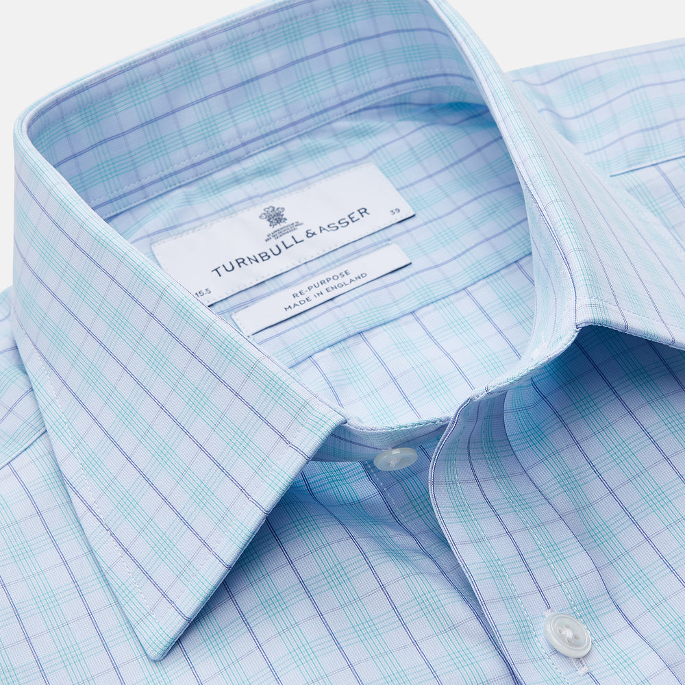 The Turnbull & Asser Pale Blue and Green Multi Check Cotton Regular Fit Mayfair Shirt features a classic collar, long sleeves, white buttons, and a subtle checkered pattern—an essential for any men’s wardrobe, shown on a plain white background.