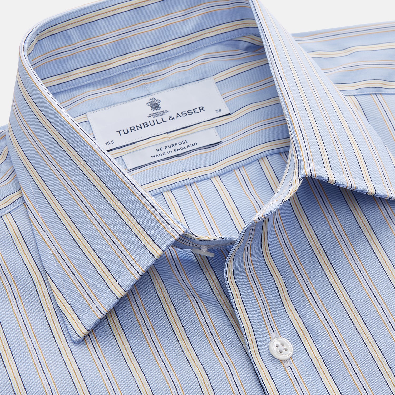 View 4 of product The Turnbull & Asser Blue and Yellow Multi Stripe Cotton Regular Fit Mayfair Shirt features thin vertical stripes in white, blue, and tan, a collared design with white buttons—an essential formal staple for any man’s wardrobe.