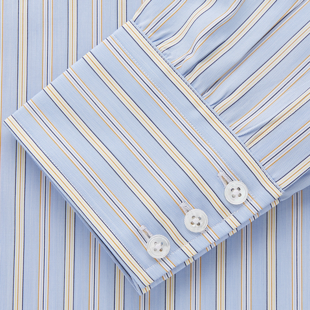The Turnbull & Asser Blue and Yellow Multi Stripe Cotton Regular Fit Mayfair Shirt features thin vertical stripes in white, blue, and tan, a collared design with white buttons—an essential formal staple for any man’s wardrobe.