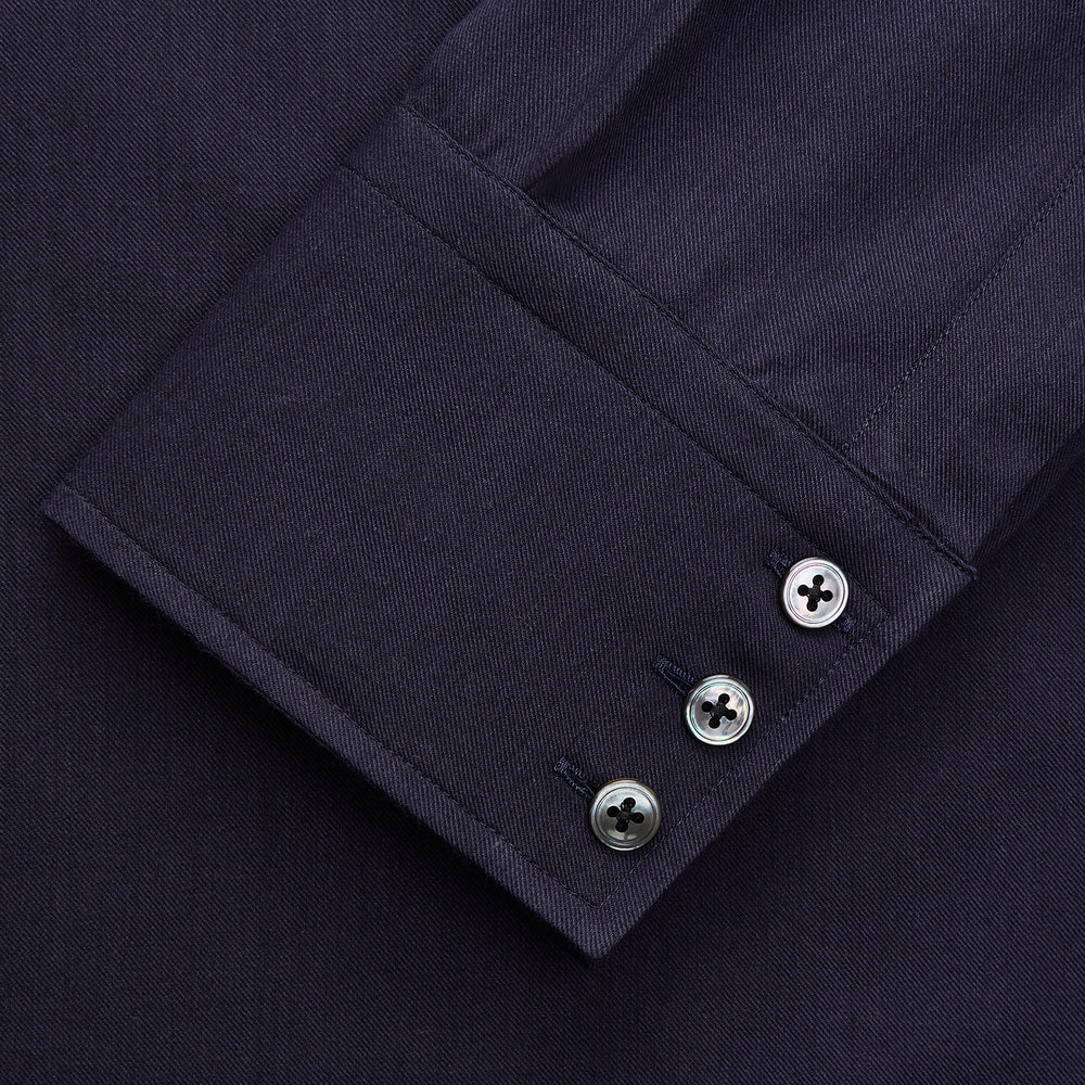 The Turnbull & Asser Navy Cotton and Wool Blend Regular Fit Mayfair Shirt features long sleeves, white buttons, a classic collar, and cuffed sleeves—a refined addition to the Mayfair collection.