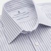 View 4 of product The Turnbull & Asser White and Blue Halo Stripe Cotton Regular Fit Mayfair Shirt features thin vertical stripes, a classic collar, and cuffed long sleeves—an essential men's formal shirt shown laid flat on a white background.