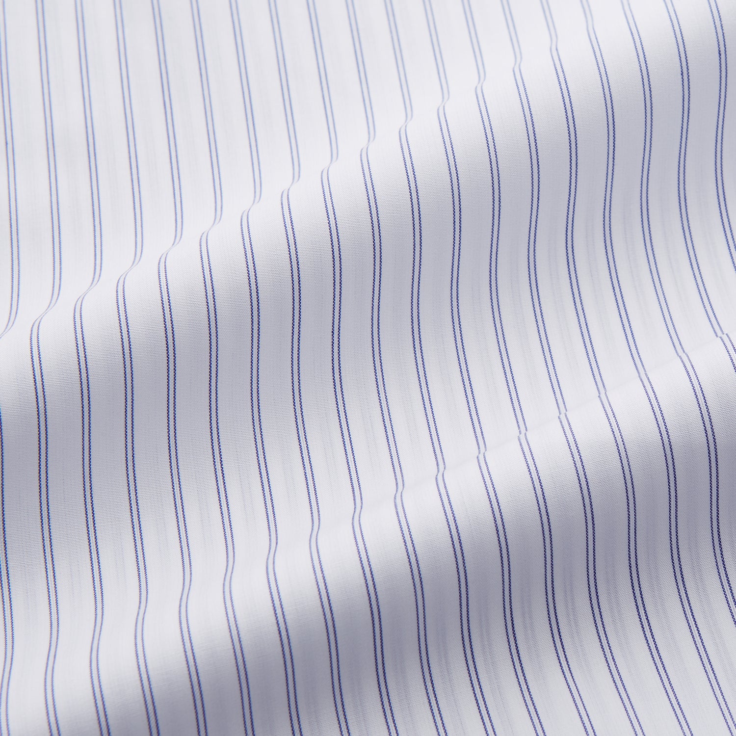 View 3 of product The Turnbull & Asser White and Blue Halo Stripe Cotton Regular Fit Mayfair Shirt features thin vertical stripes, a classic collar, and cuffed long sleeves—an essential men's formal shirt shown laid flat on a white background.