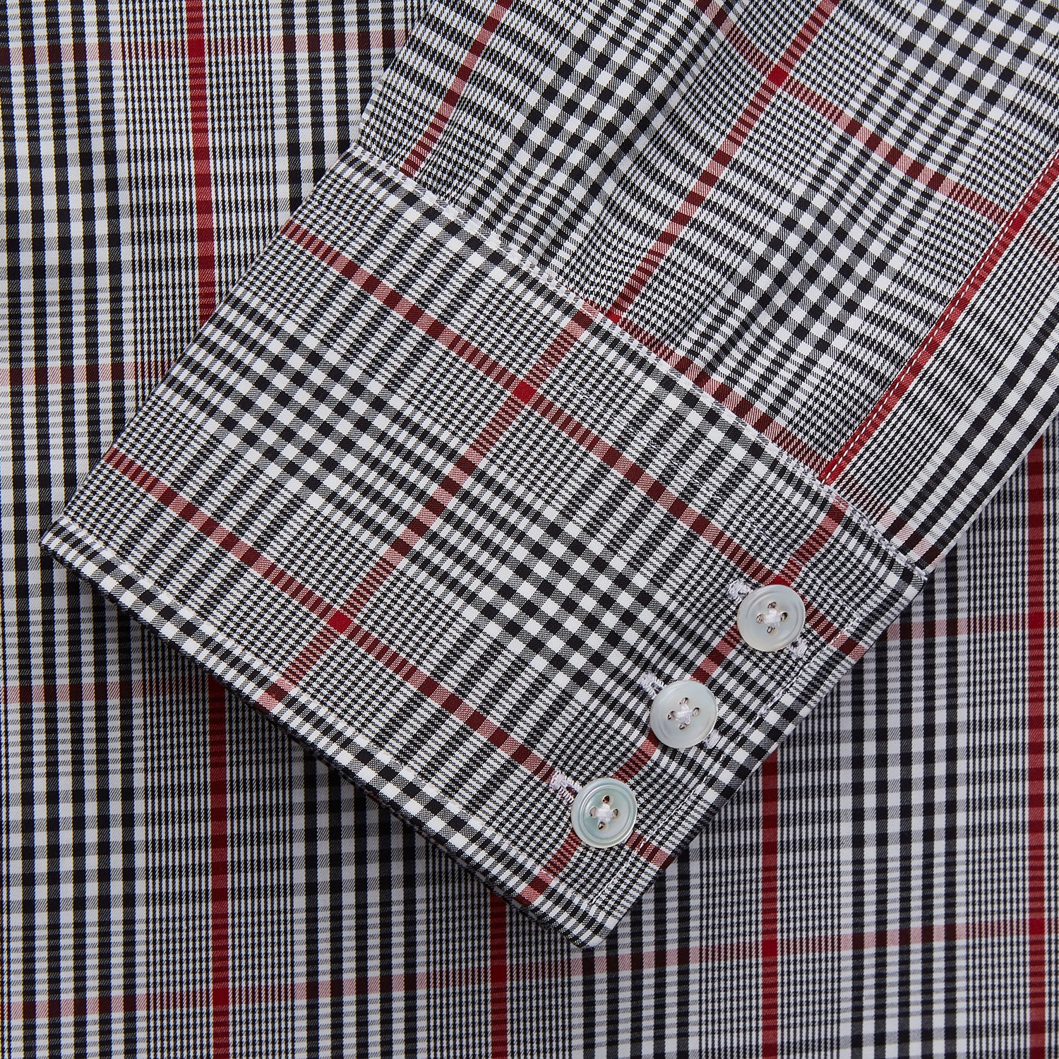 View 2 of product The Turnbull & Asser Black Prince of Wales Check Cotton Regular Fit Mayfair Shirt, featuring a button-up design and pointed collar, is a classic men's wardrobe staple in black, white, and red check.