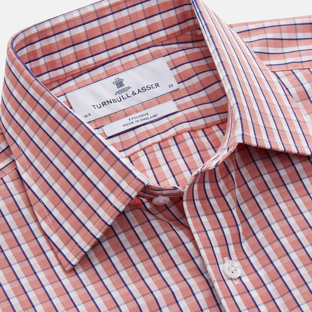 The Turnbull & Asser Orange and White Check Cotton Regular Fit Mayfair Shirt features a classic Mayfair collar and white buttons, shown laid flat on a white background.