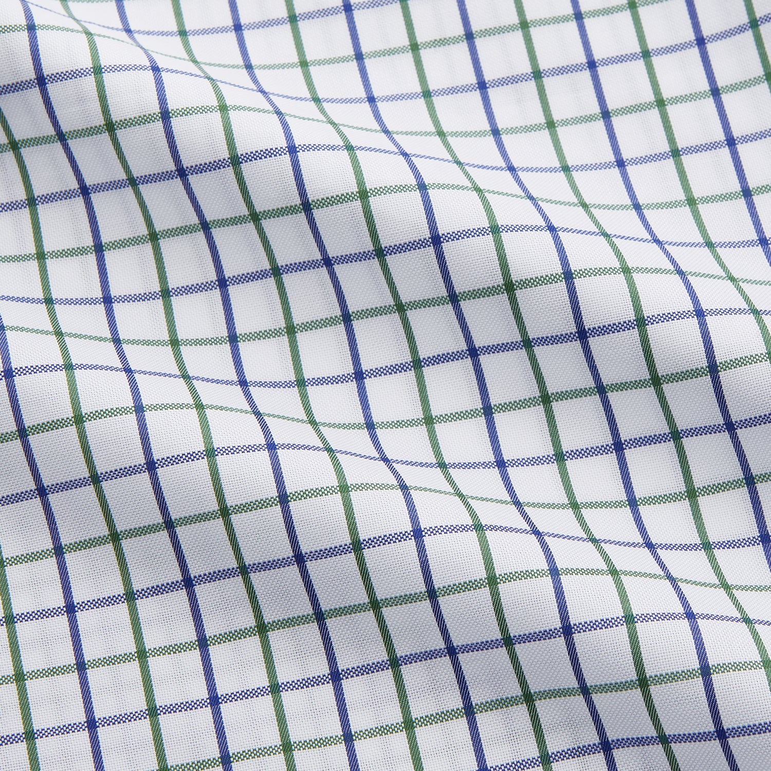 View 4 of product The Turnbull & Asser Green and Blue Check Cotton Tailored Fit Shelton Shirt for men features a crisp white base with a green and blue check pattern, shown laid flat on a white background.