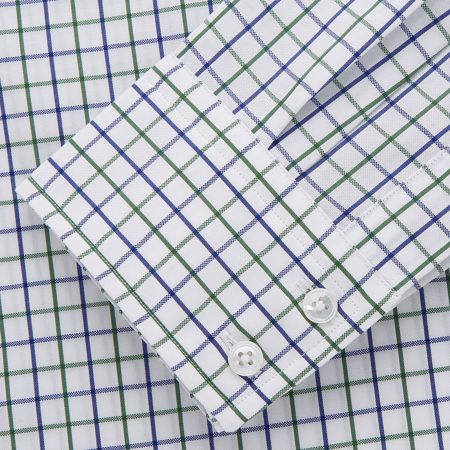 View 3 of product The Turnbull & Asser Green and Blue Check Cotton Tailored Fit Shelton Shirt for men features a crisp white base with a green and blue check pattern, shown laid flat on a white background.
