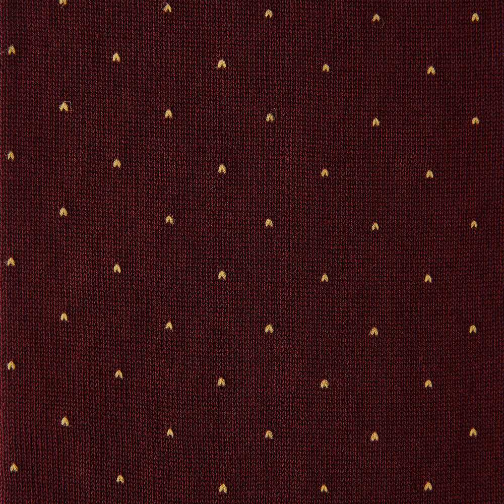 Turnbull & Asser’s Burgundy and Gold Polka Dot Cotton Mid-length Socks, shown on a white background, feature small gold dots for a stylish touch to elevate any office outfit.